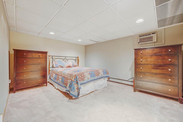 1041 N 6th St, New Hyde Park, NY 11040 - bedroom featuring a drop ceiling, carpet, a wall unit AC, a baseboard heating unit, and recessed lighting