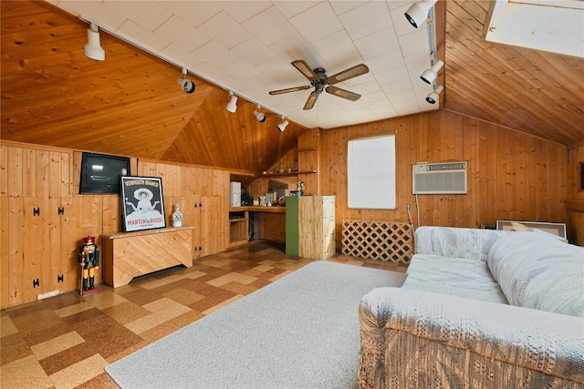 living area with wood walls, a wall unit AC, rail lighting, and lofted ceiling