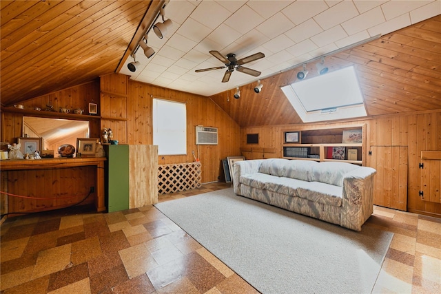 bedroom with track lighting, lofted ceiling with skylight, wooden walls, and tile patterned floors