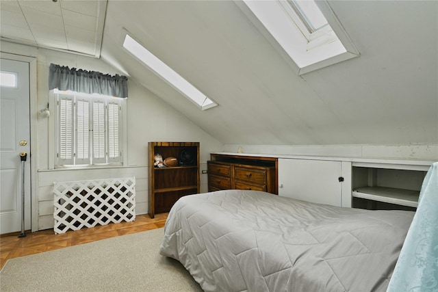 bedroom with lofted ceiling with skylight