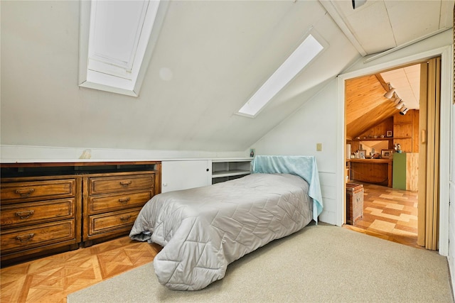 bedroom featuring lofted ceiling with skylight
