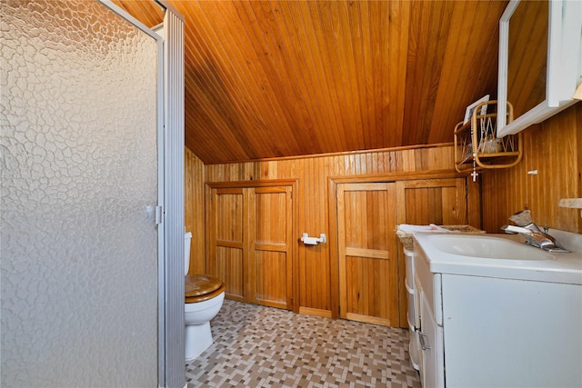 bathroom featuring wood ceiling, wooden walls, toilet, vaulted ceiling, and vanity