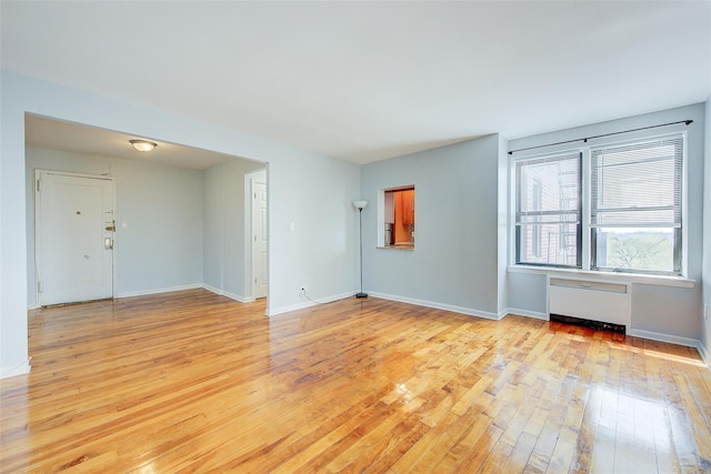 170-06 Crocheron Ave Unit 5D, Flushing, NY 11358 - spare room with radiator, baseboards, and light wood finished floors