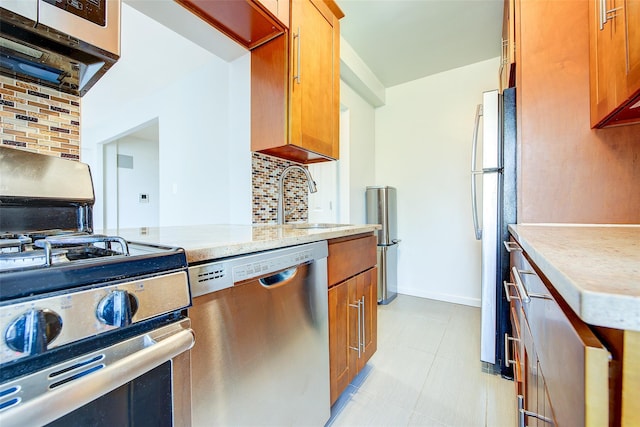 170-06 Crocheron Ave Unit 5D, Flushing, NY 11358 - kitchen with decorative backsplash, a sink, brown cabinets, and stainless steel appliances