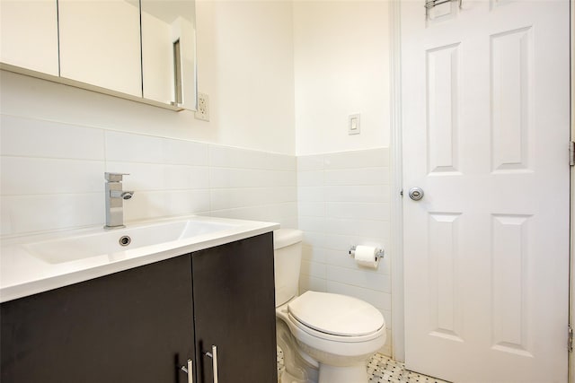 170-06 Crocheron Ave Unit 5D, Flushing, NY 11358 - bathroom featuring wainscoting, tile walls, vanity, and toilet