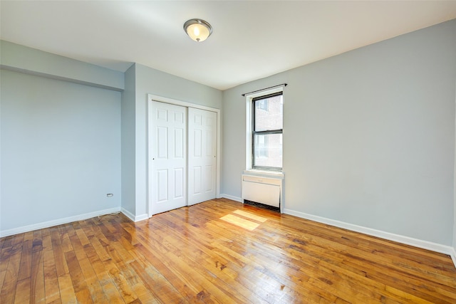 170-06 Crocheron Ave Unit 5D, Flushing, NY 11358 - unfurnished bedroom with a closet, baseboards, and light wood-type flooring