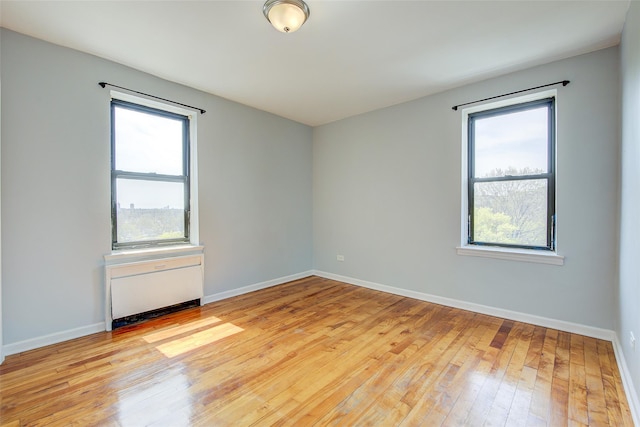 170-06 Crocheron Ave Unit 5D, Flushing, NY 11358 - unfurnished room with baseboards and wood-type flooring