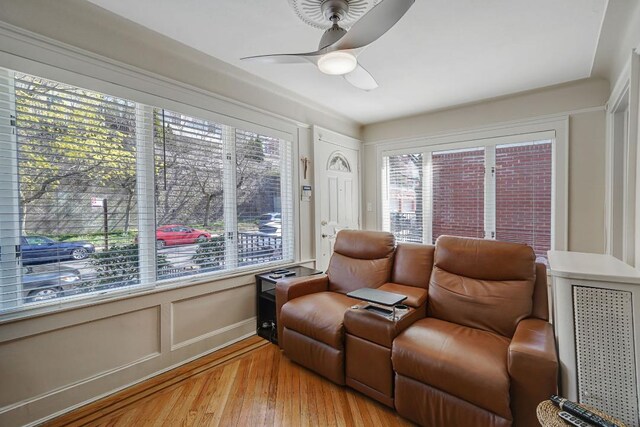 sitting room featuring light wood-style flooring and ceiling fan