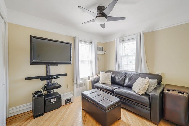 living room featuring ceiling fan and light wood-type flooring