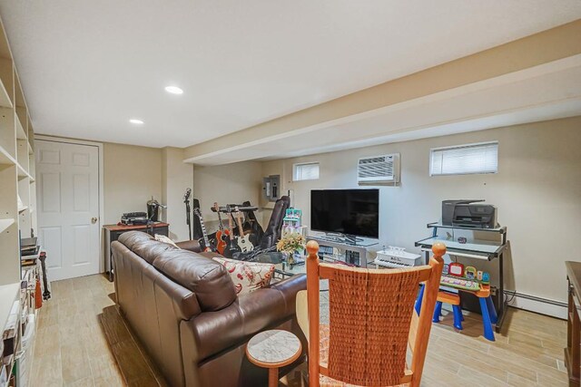 living area featuring light wood-type flooring, recessed lighting, and a baseboard heating unit
