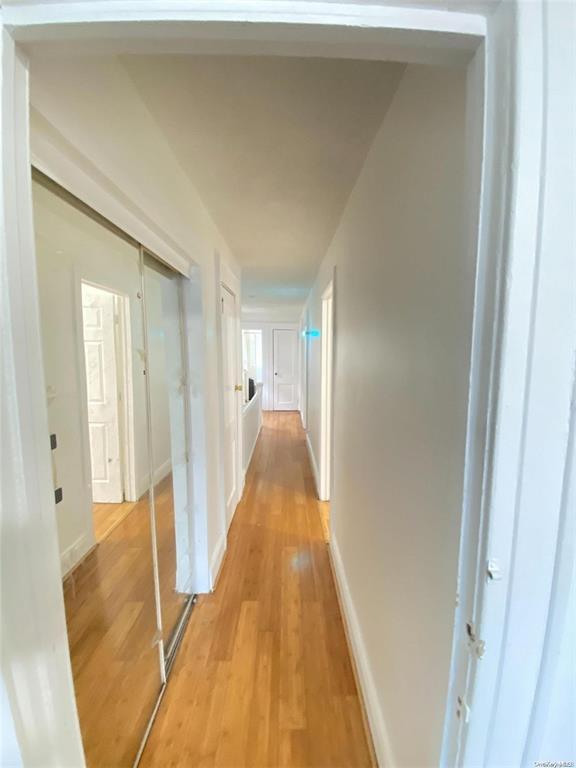 88-39 186th St, Hollis, NY 11423 - corridor featuring light wood-style floors and baseboards