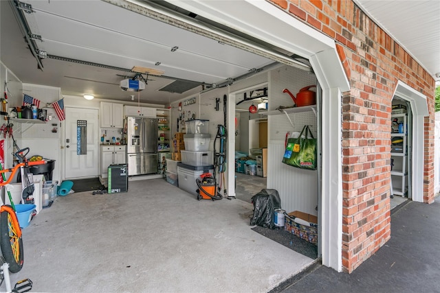 79 Birch St, Lake Grove, NY 11755 - garage with stainless steel fridge with ice dispenser and a garage door opener