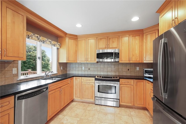 kitchen with a sink, recessed lighting, appliances with stainless steel finishes, and tasteful backsplash