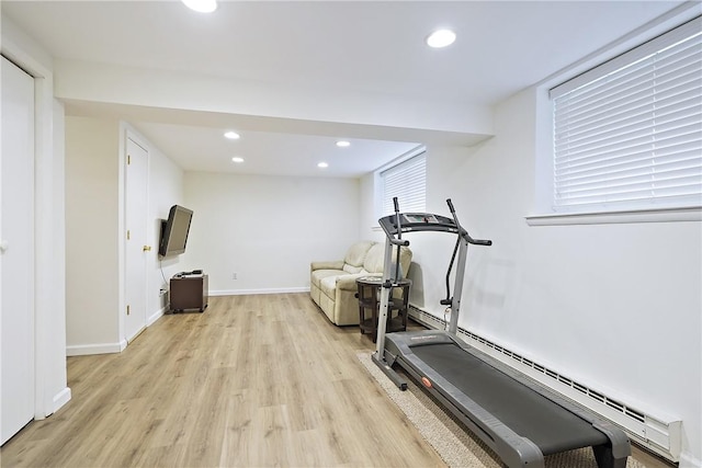 workout room featuring a baseboard radiator, recessed lighting, baseboards, and light wood-type flooring