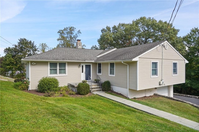 ranch-style home with an attached garage, driveway, a chimney, and a front yard