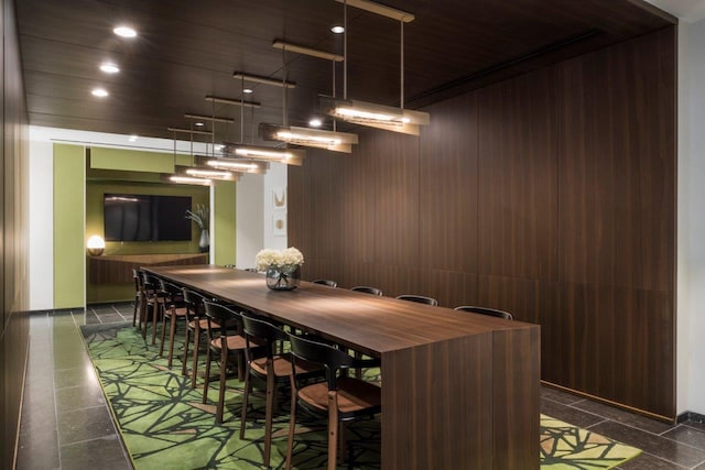 dining space with recessed lighting, wooden walls, and wooden ceiling