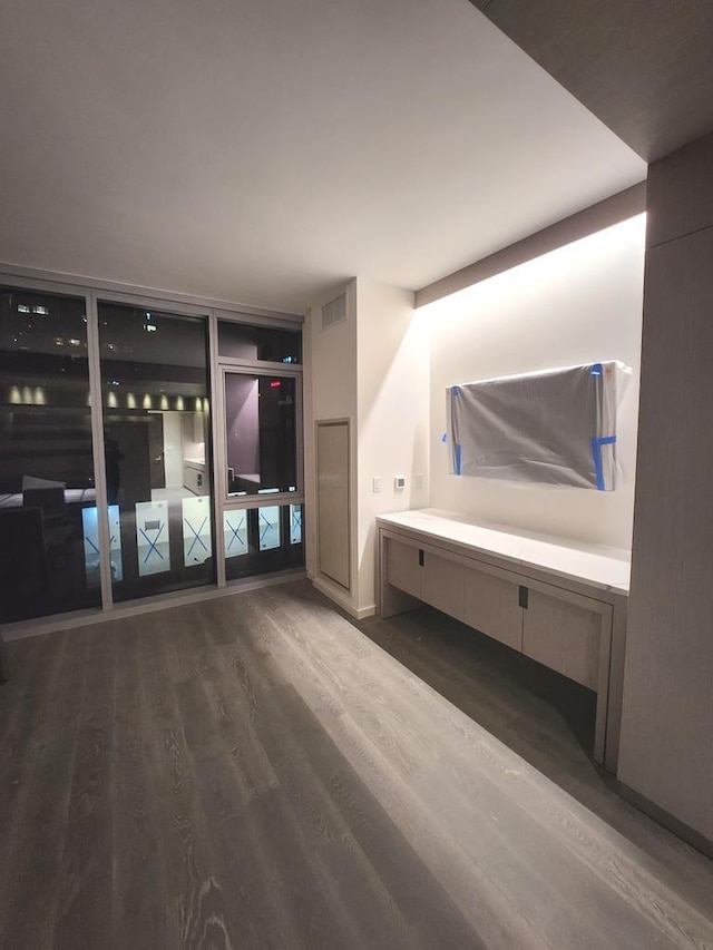interior space featuring visible vents and dark wood-style floors