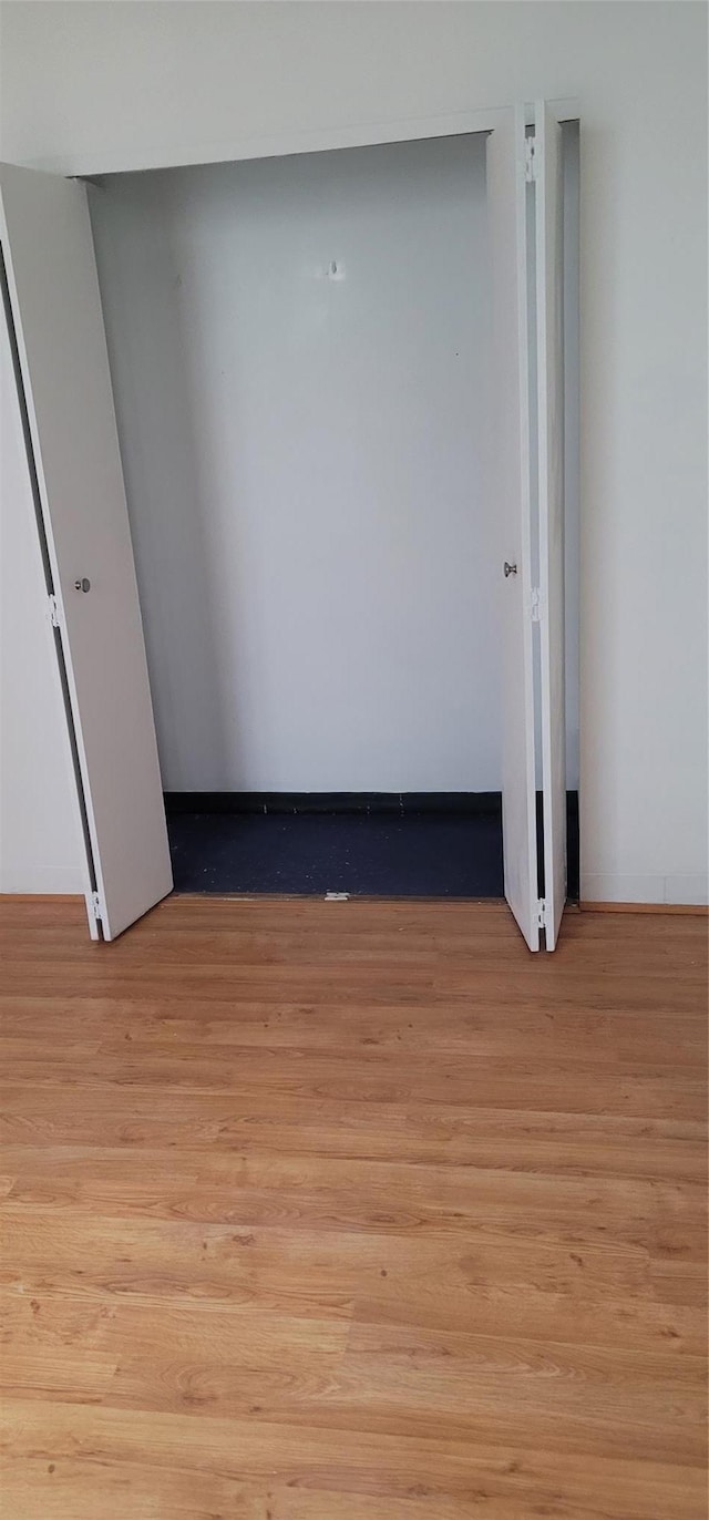 unfurnished bedroom featuring light wood-style floors