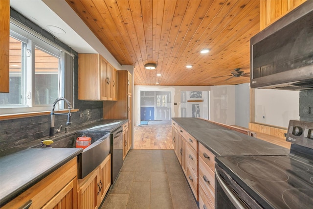 kitchen featuring stainless steel appliances, a sink, dark countertops, backsplash, and wood ceiling