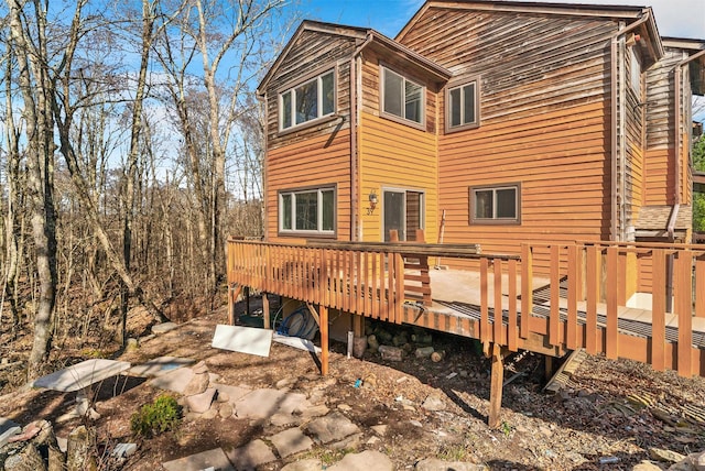 rear view of property featuring a wooden deck