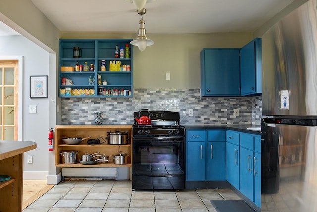 kitchen featuring blue cabinets, freestanding refrigerator, backsplash, dark countertops, and black range with gas cooktop
