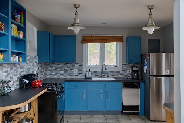 kitchen with a sink, black gas stove, blue cabinets, freestanding refrigerator, and dishwashing machine