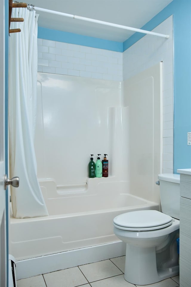 bathroom featuring tile patterned floors, toilet, and shower / bath combination with curtain