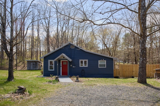 bungalow with a front lawn and fence