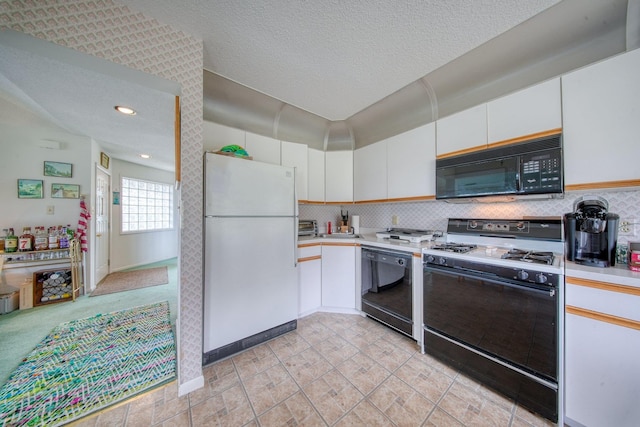 10 Joe D Dr Unit 10B, Callicoon, NY 12723 - kitchen with recessed lighting, light countertops, black appliances, tasteful backsplash, and white cabinetry