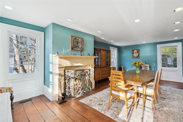 dining space with hardwood / wood-style flooring, visible vents, and recessed lighting