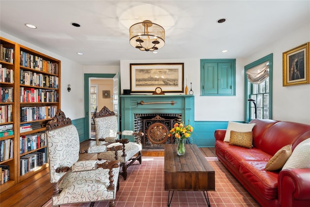 living area featuring recessed lighting, an inviting chandelier, and a fireplace