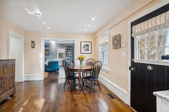 dining space with baseboards, dark wood-style flooring, visible vents, and recessed lighting