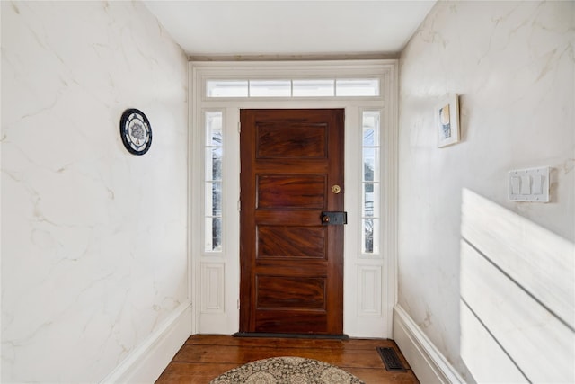 entryway featuring wood finished floors, visible vents, and a wealth of natural light