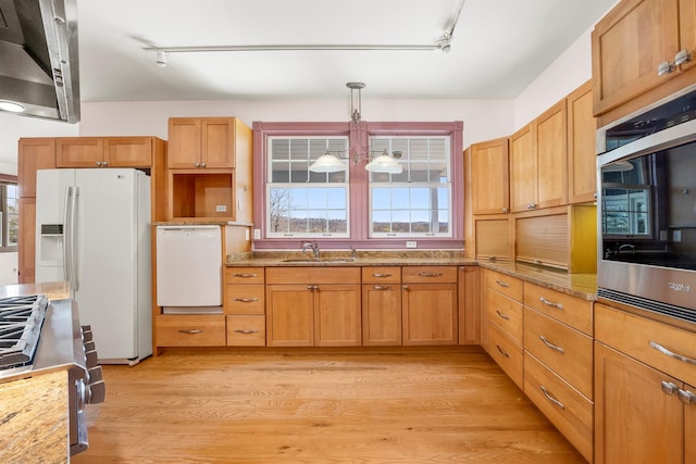 kitchen featuring track lighting, light wood finished floors, a sink, and white appliances