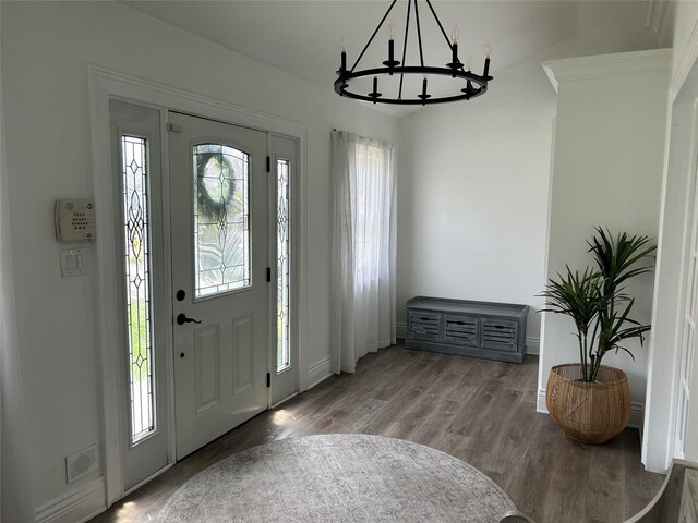 entrance foyer featuring a notable chandelier, wood finished floors, visible vents, and plenty of natural light