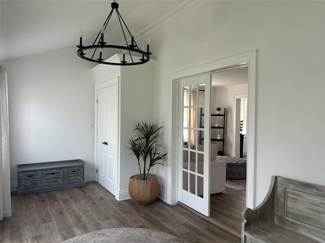 dining area with wood finished floors, baseboards, ornamental molding, and an inviting chandelier