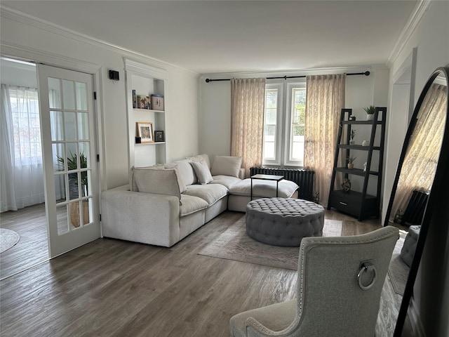 living area featuring radiator, ornamental molding, and wood finished floors