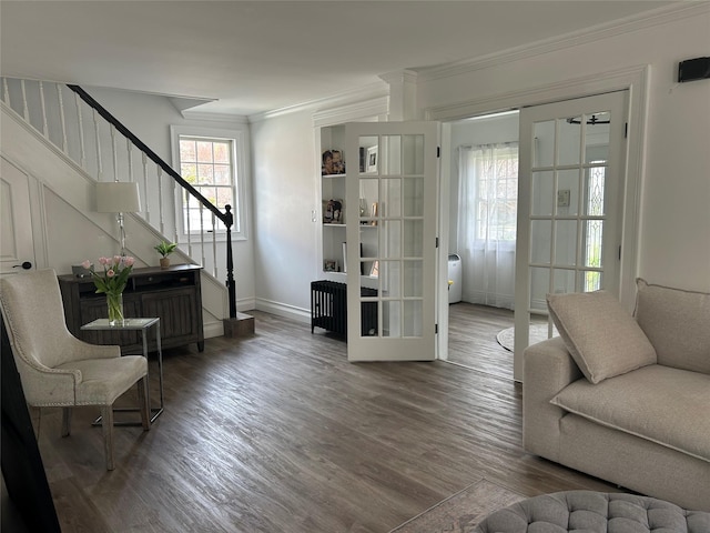 interior space with baseboards, wood finished floors, crown molding, and stairs