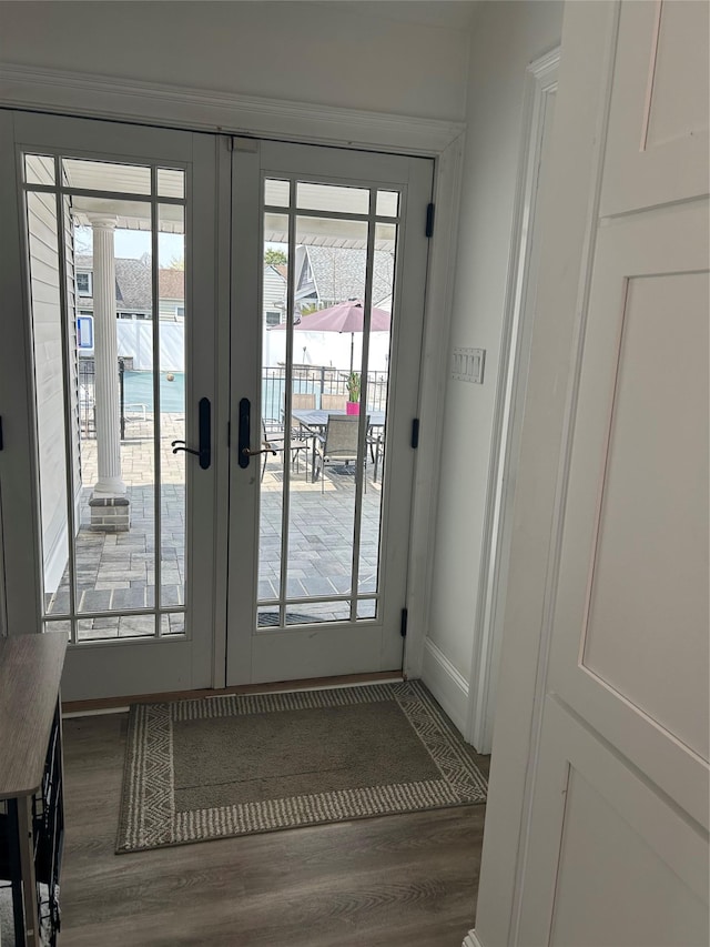 doorway with baseboards, french doors, and wood finished floors