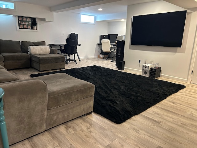 living area with baseboards and wood finished floors