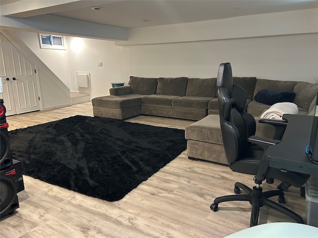 living area featuring wood finished floors and stairway