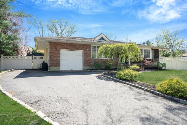 92 Dovecote Ln, Commack, NY 11725 - ranch-style house featuring a front lawn, aphalt driveway, fence, brick siding, and an attached garage