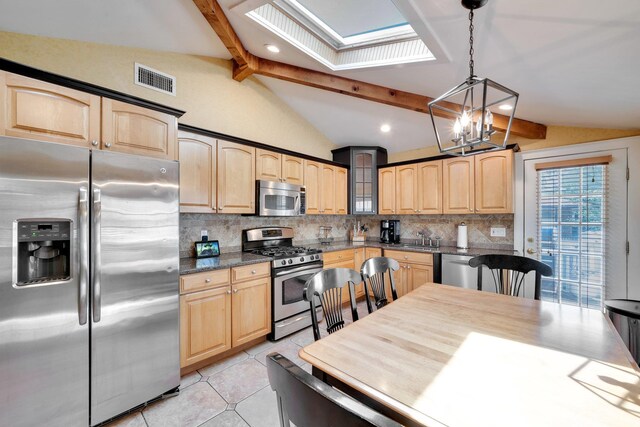 92 Dovecote Ln, Commack, NY 11725 - kitchen featuring light brown cabinetry, a notable chandelier, appliances with stainless steel finishes, and lofted ceiling with skylight
