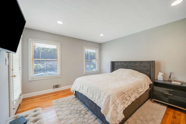 92 Dovecote Ln, Commack, NY 11725 - bedroom featuring recessed lighting, baseboards, visible vents, and wood finished floors