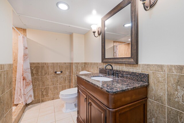 92 Dovecote Ln, Commack, NY 11725 - bathroom featuring wainscoting, tile walls, vanity, and toilet