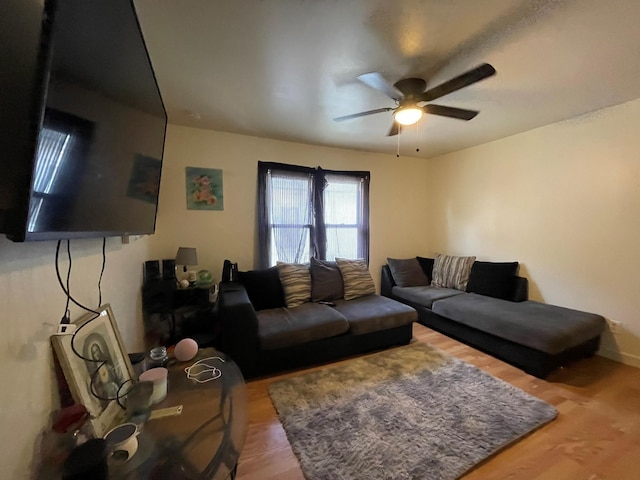 living room with wood finished floors and ceiling fan