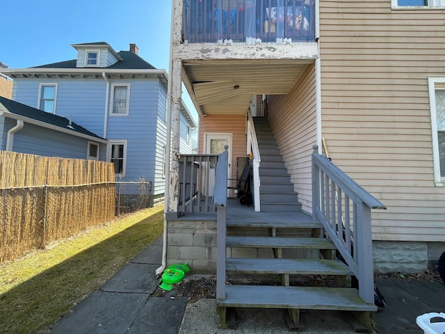 doorway to property featuring fence