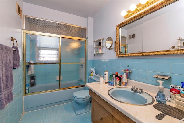3530 Long Beach Rd Unit 68, Oceanside, NY 11572 - bathroom with vanity, tile patterned floors, tile walls, visible vents, and bath / shower combo with glass door