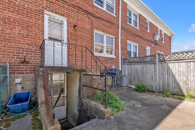 3530 Long Beach Rd Unit 68, Oceanside, NY 11572 - exterior space with brick siding, central AC, and fence