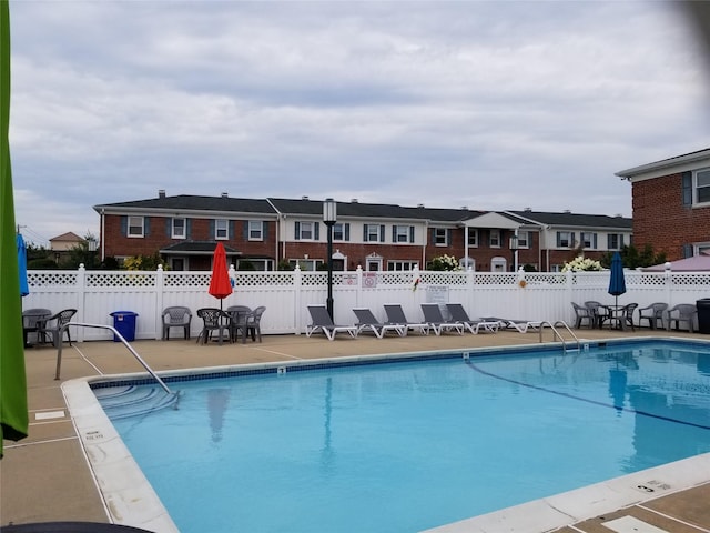 3530 Long Beach Rd Unit 68, Oceanside, NY 11572 - pool featuring a patio, fence, and a residential view